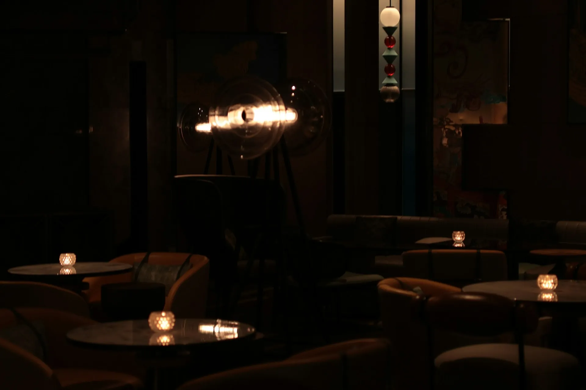 A dimly lit hotel bar with warm glowing candles