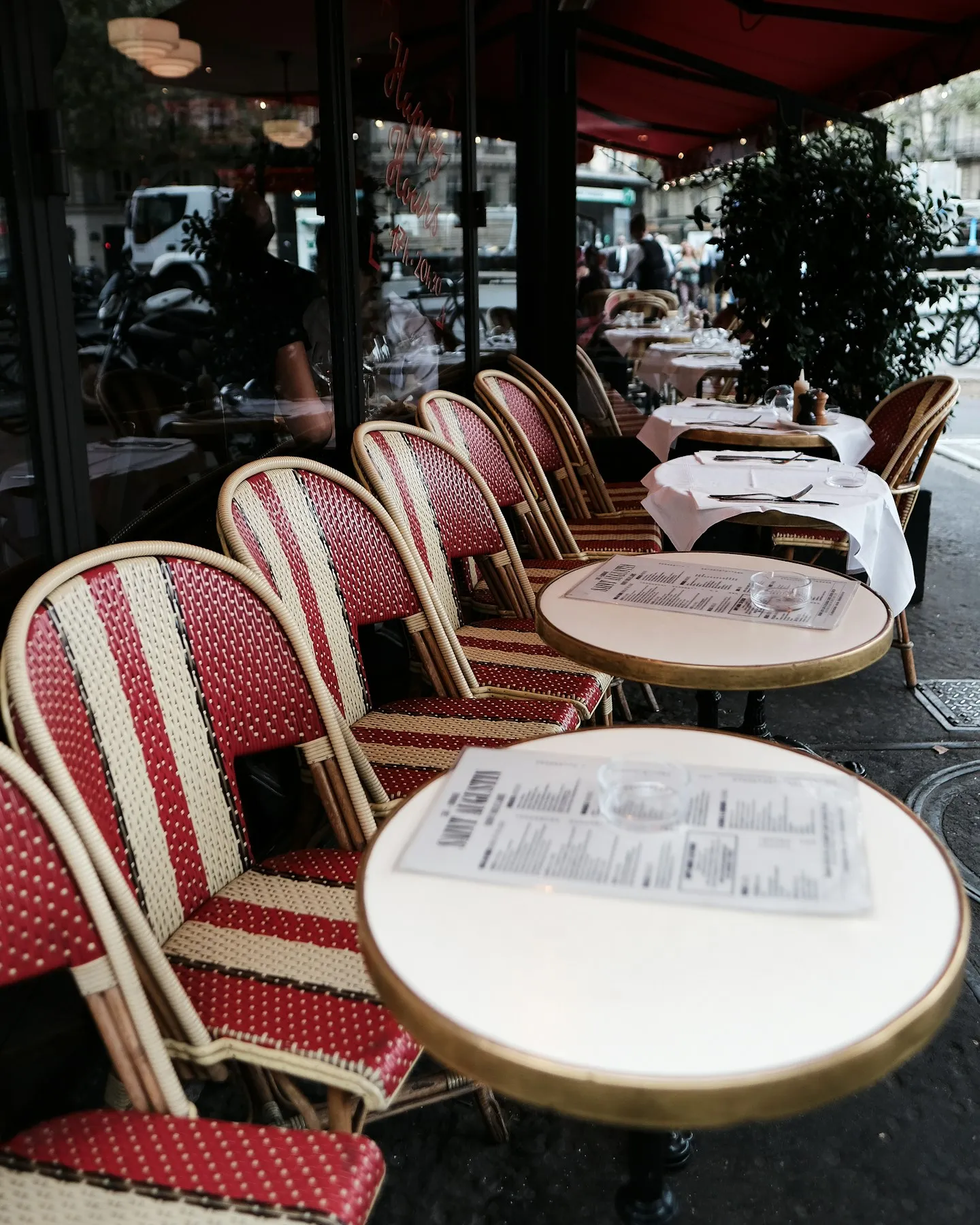 A Parisian bistro terrace with woven chairs