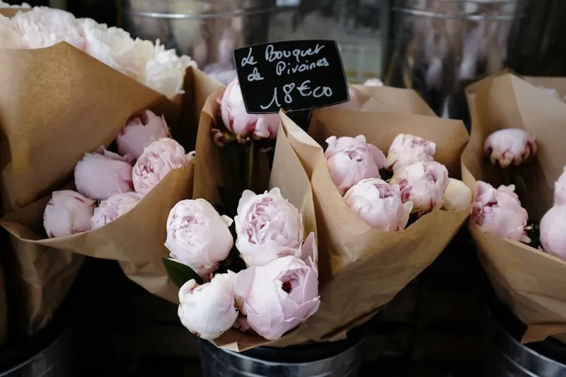 Peonies wrapped in paper at a flower market