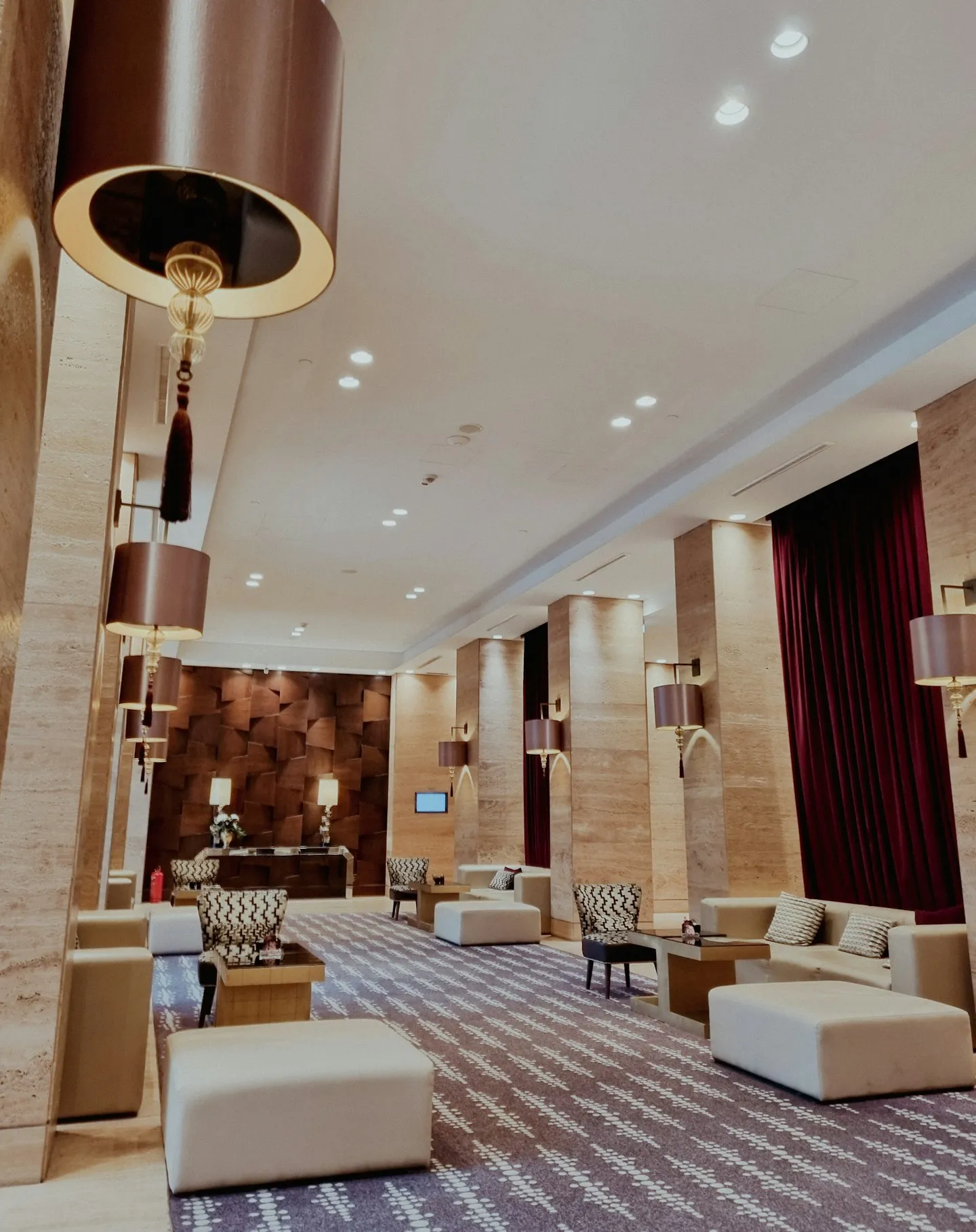 A warm hotel lounge with travertine walls