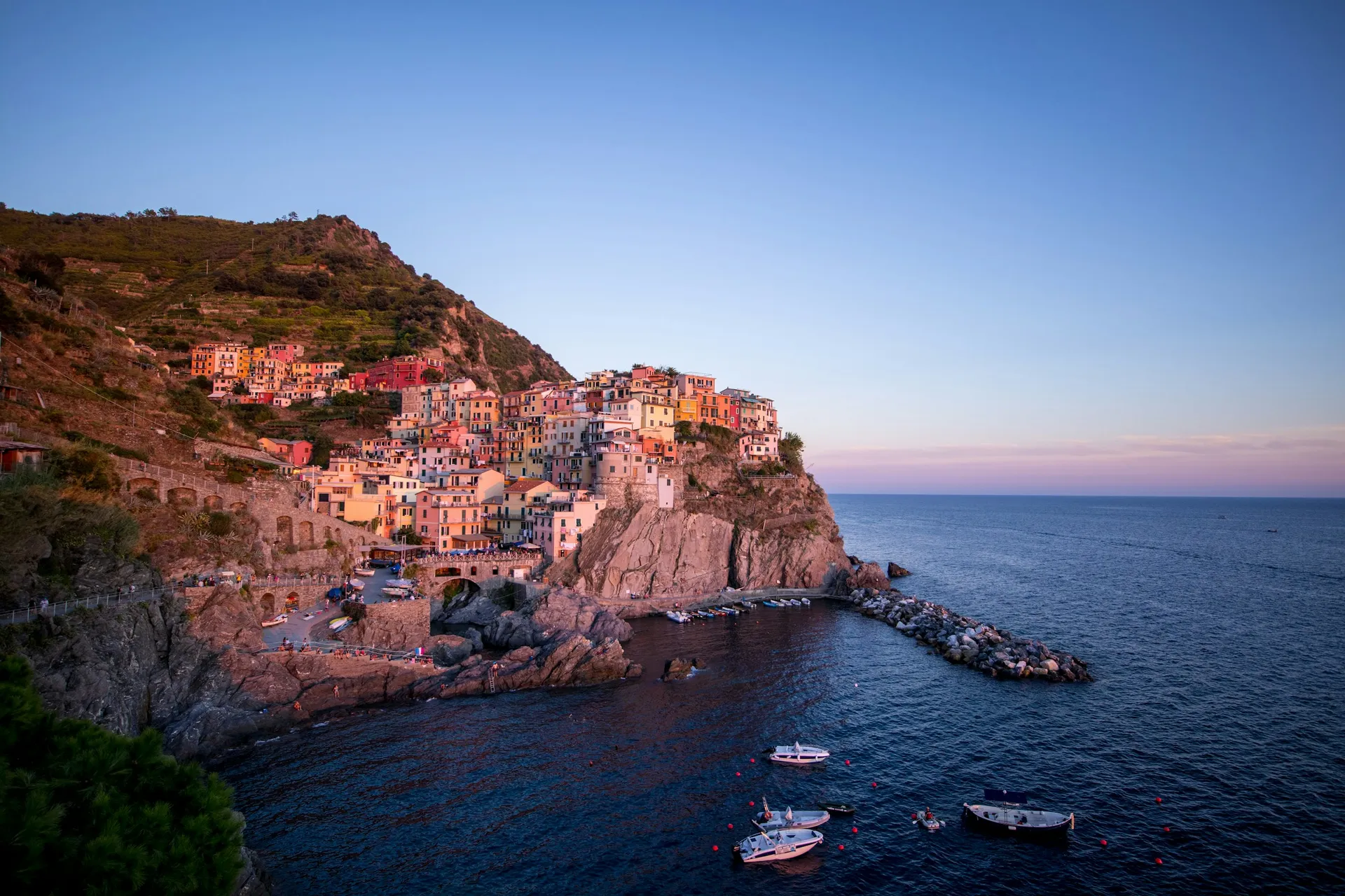 A coastal village on cliffs above the Mediterranean at sunset